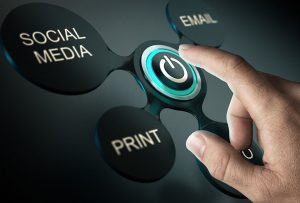 finger about to touch social media, print, and email marketing control button